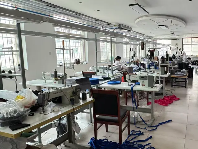 Sewing operators assembling backpack bodies on the production line