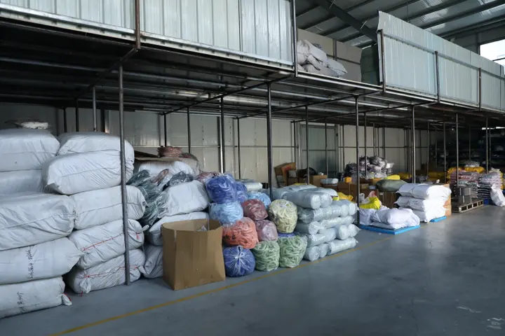 Mixed-colour stock backpacks staged for a wholesale order