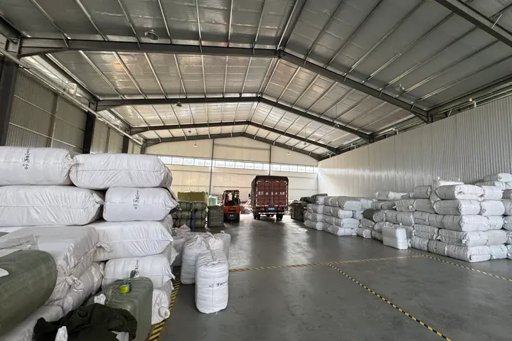 Palletised bales of finished backpacks staged at the Senszx loading bay